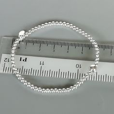 This is a sterling silver bracelet made with small beads. Diameter: 7.5 inches Beads: 2mm Big Bead: 5mm This bracelet is made of 925 hypoallergenic sterling silver. This piece is sent in a gift box. I can include a personal message from you if needed You are welcome to contact me at... bhavnakwintra1956@gmail.com For more beautiful pieces from my shop, please browse 👇 TOE RINGS: https://www.etsy.com/your/shops/TheSilverGame/tools/listings/section:27020628,view:table EAR HOOPS: https://www.etsy. White Gold Sterling Silver Bracelets With Silver Beads, Silver Bracelets With Spacer Beads, Sterling Silver Bracelets With Silver Beads, Everyday Sterling Silver Bracelet With Silver Beads, Silver Sterling Bracelets With Round Beads, Silver Charm Bracelet With Silver Beads, Everyday Silver Charm Bracelet With Silver Beads, Silver Round Charm Bracelet With Silver Beads, Round Silver Charm Bracelet With Silver Beads