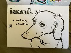 a drawing of a dog on a piece of paper next to some grafitti