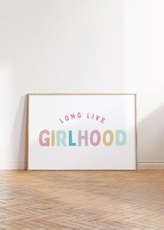 a poster with the words long live girlhood on it in front of a white wall