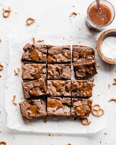 chocolate brownies cut into squares on top of parchment paper next to salt and spoon