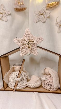 a wooden box filled with baby booties on top of a white sheet covered floor