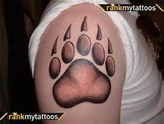 an animal paw tattoo on the arm