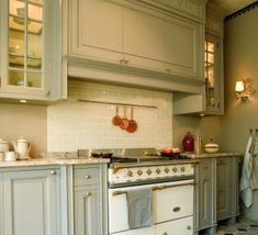 a kitchen with an oven, stove and cabinets in it's center island area