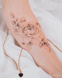 a woman's foot with a flower tattoo on it