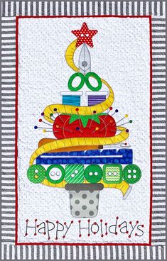 a quilted christmas tree with scissors and yarns on it's top, in front of a striped background