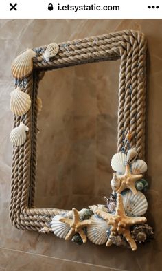 a rope frame with seashells and starfish on it