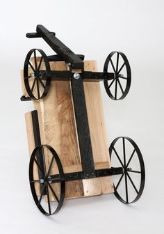 an old wooden cart with wheels on it