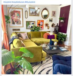 a living room filled with furniture and lots of plants