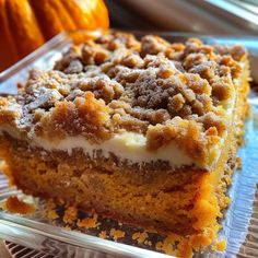 a close up of a piece of cake on a plate with pumpkins in the background