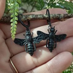 Black Bee Earrings Simple and Realistic Black Bees dangle from gunmetal rings and black lever back ear wires - the perfect way to honor our pollinating friends. Each pair made with care in my Punta Gorda Studio. These Goth Bee Earrings are an ideal gift for the Bee Keeper or Gardener on your list. Classic French rench hook ear wires available upon request. Your Black Bee Dangles will arrive beautifully packaged in an organza pouch with a matching polishing cloth. Take a few minutes to peruse all Witchy Black Dangle Jewelry, Army Dreamers, Bee Wing Jewelry, Black Victorian Dangle Earrings, Tiny Bee Earrings, Gold Bee Earrings, Black Bee, Bee Lover Gifts, Bee Keeper