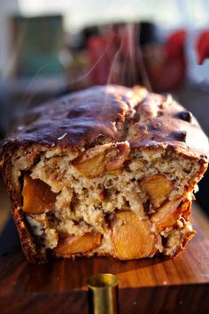 a loaf of bread sitting on top of a wooden cutting board