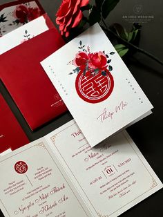 red and white wedding stationery with flowers on it, along with matching envelopes