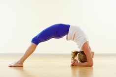 a woman is doing a yoga pose on the floor