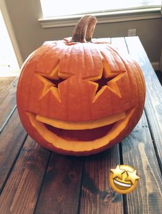 a carved pumpkin sitting on top of a wooden table