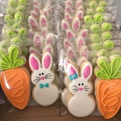 decorated cookies in the shape of carrots and bunnies with bunny ears on them