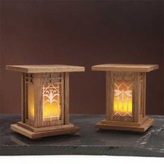 two wooden lanterns sitting on top of a table