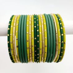 Beautifully designed bangles for any occasion. South asian bracelets come in a variety of styles, colors, and finishes. We at Banglez take creating the perfect bangle set for you to another level! You could say helping you find your favorite stack of bangles as one of our greatest missions. This bangle set was curated in house by one of our talented team members. We hope you love them as much as we do! Festive Handmade Yellow Bracelets, Adjustable Yellow Bangle For Festivals, Traditional Stackable Bangle Cuff Bracelet, Adjustable Green Bangle For Wedding, Traditional Green Bangle Cuff Bracelet, Festival Stackable Bangles, Green Adjustable Cuff Bracelet For Wedding, Adjustable Green Cuff Bracelet For Wedding, Festive Green Beaded Bangle Bracelets