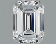 an emerald cut diamond on a gray background