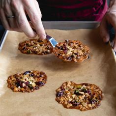 a person is cutting up some cookies on a tray