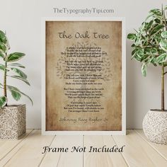 the oak tree poem framed in front of two potted plants on a wooden table