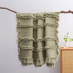 a towel hanging on a clothes line next to a dresser