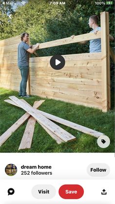 two men working on a wooden fence with the words dream home below it and below them