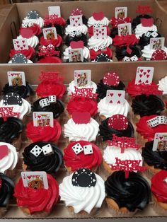 cupcakes decorated with red, white and black icing are in a box