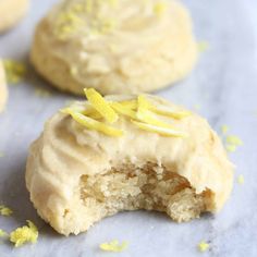 two cookies with frosting and lemon zest sprinkles