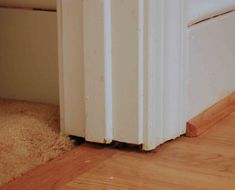 the corner of a room with wood flooring