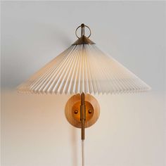 a wall lamp with a wooden base and shade