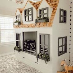 a white doll house with windows and lots of decorations