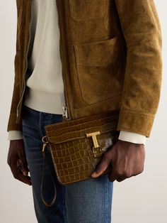 TOM FORD's accessories are as refined as its expertly tailored suiting. Designed with a practical wrist strap, this pouch has been crafted in Italy from glossed croc-effect leather and fastens with a signature gold-tone 'T Pin'. It features an internal slip pocket for cards, so you can leave your wallet at home. Designer Textured Leather Clutch For Business, Designer Textured Leather Business Clutch, Formal Leather Pouch With Coin Pocket, Timeless Business Clutch With Gold-tone Hardware, Designer Business Clutch With Gold-tone Hardware, Classic Formal Pouch With Coin Pocket, Classic Business Clutch With Palladium Hardware, Formal Clutch Pouch With Coin Pocket, Brown Luxury Business Pouch