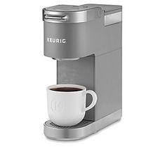 a coffee maker with a cup on the side