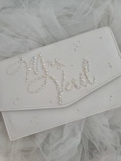 A beautiful little clutch bag to keep a selection of bridal essentials, a place to keep your lipstick, perfume, phone, hair pins!  customise with your married name as a sparkling keepsake, can even be used to accessorise your hen party wardrobe! detachable chain,  width 25cm Height 15cm depth 4cm Please message with name you would like adding to your bag ❤️ Personalized White Bag For Wedding Gift, Silver Envelope Clutch For Wedding, Elegant Rectangular Bag For Wedding Gift, Elegant White Bag As A Wedding Gift, Elegant Personalized Wedding Bags, Bridal Essentials, Custom Fitted Hats, Bridal Clutch Bag, Bridal Clutch