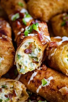 some food that is laying on top of each other in a pan with cheese and bacon