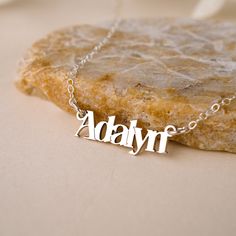 Discover the luxurious charm of the Malibu Name Necklace! Handcrafted with love and attention-to-detail, this gorgeous necklace is the perfect way to show off your name with style. Layer with your favorite necklaces for a boho glam look. NECKLACE FEATURES Choice of Finish: 18k gold plating over sterling silver or Sterling Silver handcrafted custom name pendant. Choice of Size: Small (approx. 3/4 inch) or Large (approx. 1.25 inches) Gold filled or sterling silver cable chain. All necklace finding Personalized Name Pendant Necklace, Trendy Personalized Necklace For Gift, Everyday Adjustable Charm Necklaces With Custom Name, Everyday Adjustable Charm Necklace With Custom Name, Everyday Adjustable Custom Name Charm Necklaces, Trendy Custom Name Jewelry For Everyday Wear, Everyday Adjustable Custom Name Charm Necklace, Trendy Custom Name Jewelry For Everyday, Personalized Pendant Necklace For Gifts