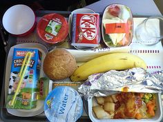 an airplane tray with food and drinks on it