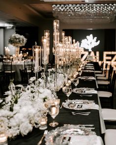 a long table is set with candles and flowers for a formal dinner or banquet event