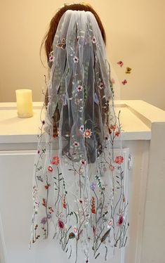 a veil with flowers hanging from it's back