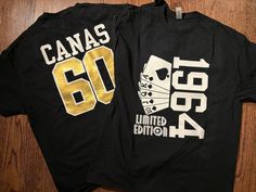 two black shirts with gold numbers on them sitting on top of a wooden floor next to each other