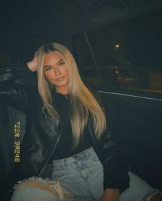 a woman sitting in the back seat of a car