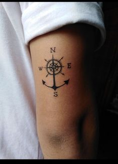 a person with a compass tattoo on their arm