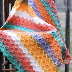 a crocheted blanket sitting on top of a wooden chair