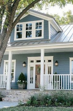 a blue house with white trim and windows