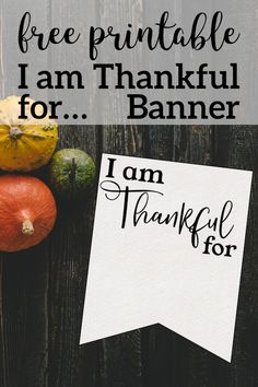 a sign that says free printable i am thanksgiving for, and some pumpkins