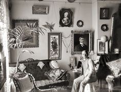 black and white photograph of a man and woman sitting on a couch in their living room