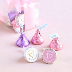 candy candies are sitting in front of a pink gift box