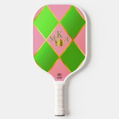 a pink and green paddle with the letter k on it