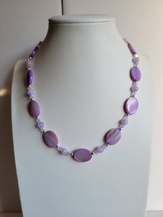 "The oval Mother-of-Pearl beads in this necklace are light purple. It has clear ab Swarovski crystal beads and Purple Galaxie Jade. The findings and remaining beads are sterling silver. It is 17.5\" long and has a 1\" extension with a beaded drop making it adjustable. Custom Orders are always welcome!" Purple Oval Beaded Necklaces For Jewelry Making, Lavender Single Strand Round Bead Jewelry, Lavender Single Strand Jewelry With Round Beads, Purple Oval Faceted Bead Necklaces, Purple Necklaces With Faceted Oval Beads, Purple Oval Beaded Necklace, Purple Beaded Oval Jewelry, Purple Jewelry With Polished Oval Beads, Purple Pearl Single Strand Jewelry