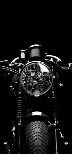 a black and white photo of a motorcycle with the clock on it's front wheel